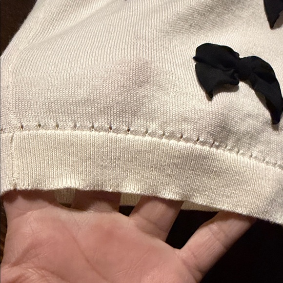 Kate Spade Ruthie Bow Cardigan in cream with black bows. - Picture 3 of 8
